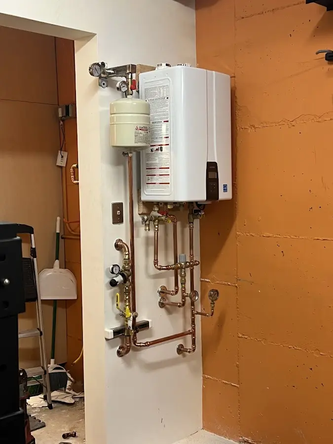 Plumbing technician inspecting water heater connections in Ellensburg